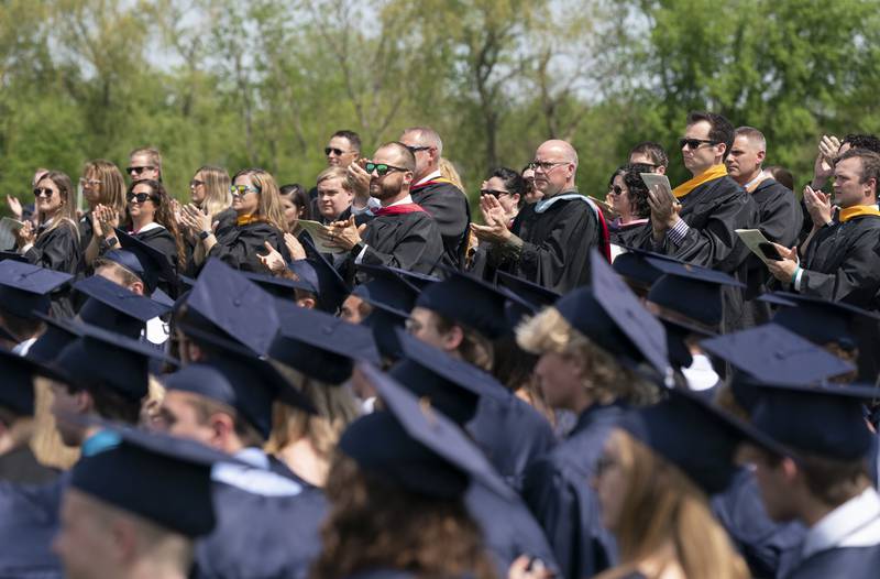 Faculty and staff clap for graduates during a graduation ceremony for the class of 2022 on Saturday, May 14, 2022, at Cary-Grove High School in Cary.