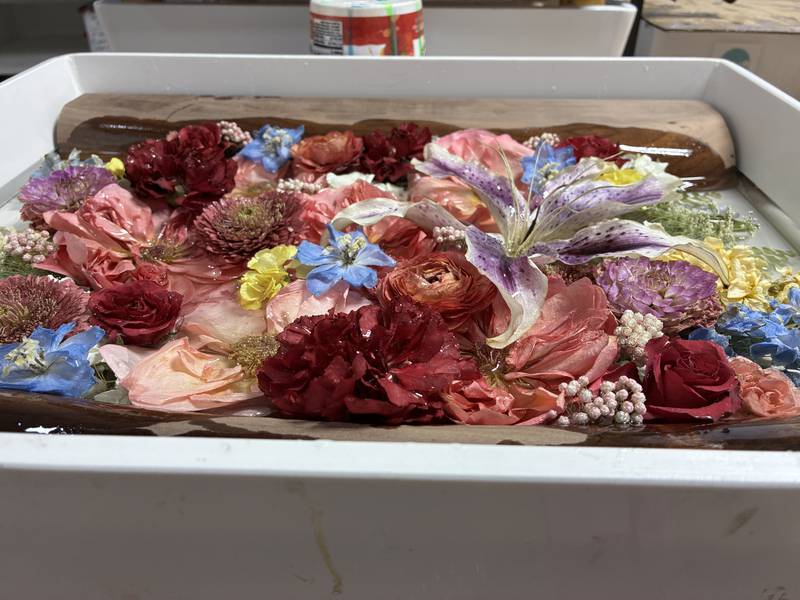 Dried flowers from a wedding arrangement at Bupp Woodworks & Designs on Nov. 28, 2025. The McHenry-based business encase the flowers in resin to preserve them.