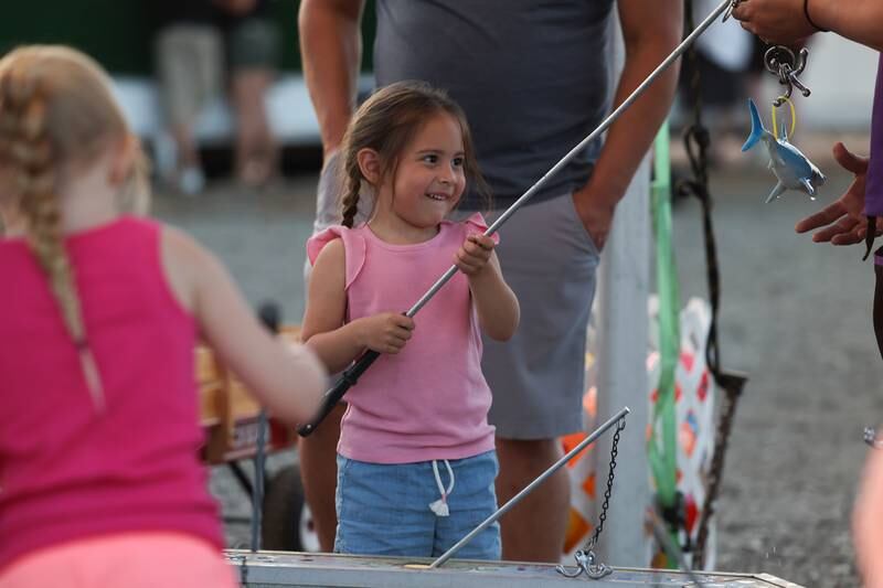 Aneli Meza, 4 years old, catches a shark at one of the carnival games at Lockport’s Canal Days on Friday, June 9, 2023.