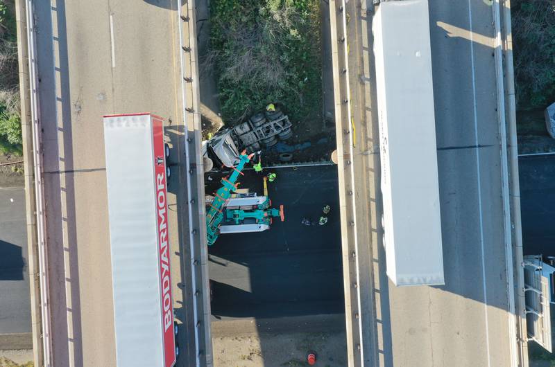 An aerial view showing emergency crews working the scene of a semi truck that struck the overpass of Illinois Route 251 and Interstate I-80 on Friday, Sept. 26, 2025 in Peru. The driver of the semi had to be extricated. Illinois State Police, Peru Fire and EMS, Senica Towing and Illinois Department of Transportation were all on the scene. The incident happened in a construction zone on Interstate I-80 shortly after 7:15a.m.