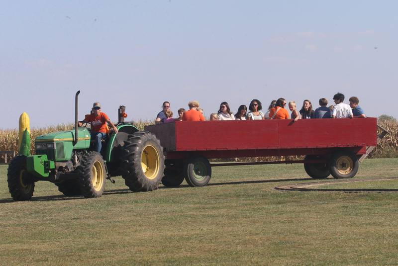 People enjoy riding a hay rack ride during the 26th Annual Pumpkin Harvest Craft Show. at Boggios Orchard and Produce on Saturday, Sept. 27, 2025 in Granville. This weekend featured the craft show, market, bakery, and pumpkin hill free of charge. There is a cost to take the kids to the play area which includes a jumping pillow, corn maze, wagon rides, a petting zoo, and playground.