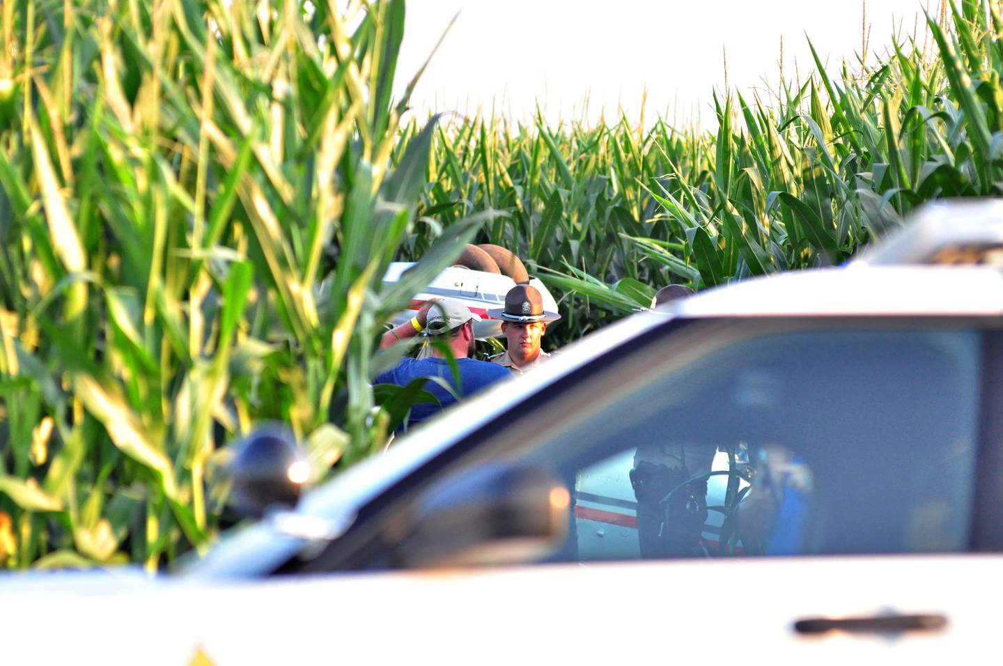 The planes landing gear can be seen upside down after landing and flipping in a corn field Saturday evening.