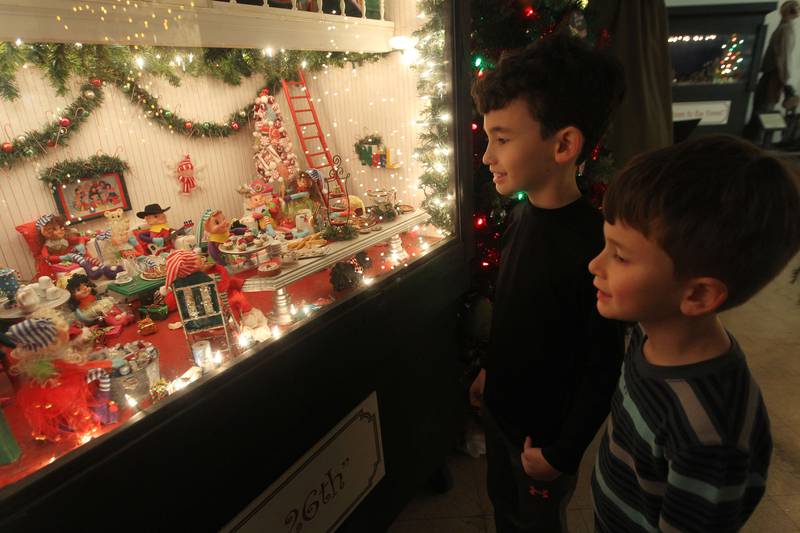 Candace H. Johnson for Shaw Local News Network
Alex Porch, 9, of Antioch and his brother, Bradley, 8, look at a holiday scene in an oversized shadowbox featured at the Kringle’s Christmas Village indoor showroom on Orchard Street in Antioch. Admission is free and it runs from Thanksgiving through New Year’s Day. (11/28/22)