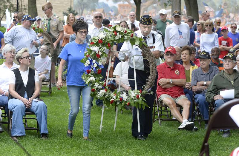Bob and Linda Cofely of Ottawa American Legion Post 33 place a wreath at the foot of Veterans Memorial Monday, May 29, 2023, at Washington Square in Ottawa during Memorial Day ceremony.