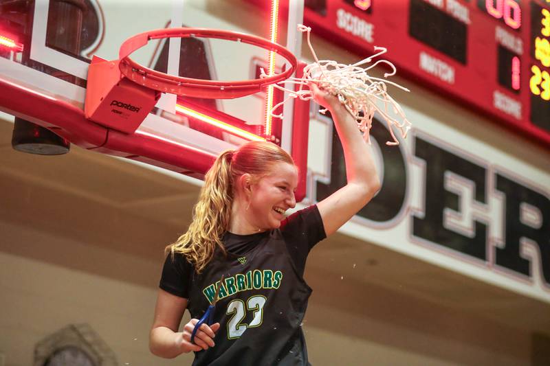 Waubonsie Valley's Lily Newton (23) shows the net to teammates after their Class 4A Bolingbrook Sectional final basketball game victory over Benet. Feb 27, 2025 in Bolingbrook.