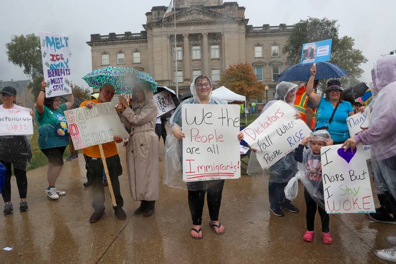 Protestors continue demonstrating as heavy rains passed through the area during the No Kings Rally on Saturday, Oct. 18, 2025, at the Kankakee County Courthouse.