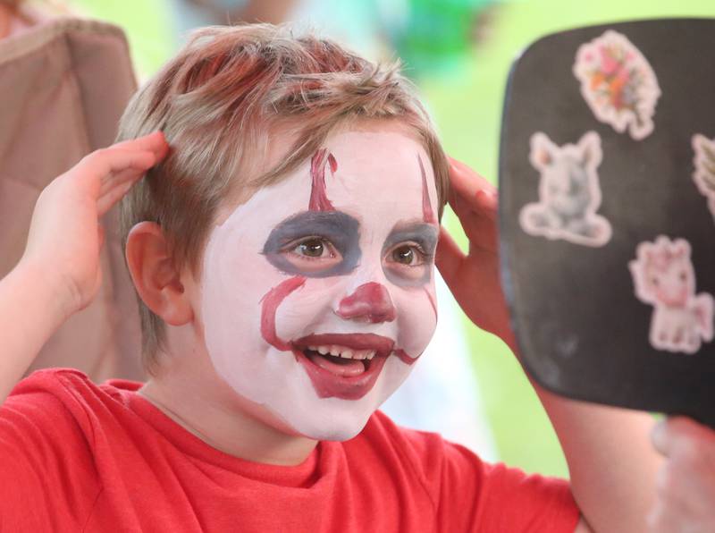 Emmett Blair of Peru, reacts after having his face painted during the The Taste of the Illinois Valley on Friday, Aug. 1, 2025 at Centennial Park in Peru. The event featured food vendors, live music, a beer tent and a kids zone, Dreamwave wrestling and Pandora's Box, a Aerosmith tribute band.