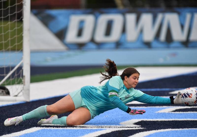 York goalkeeper Ava Lewandowski makes a diving block to deflect a Hinsdale Central shot at the goal during the Class 3A Downers Grove South Sectional final game on May 30, 2025 at Downers Grove South High School in Downers Grove .