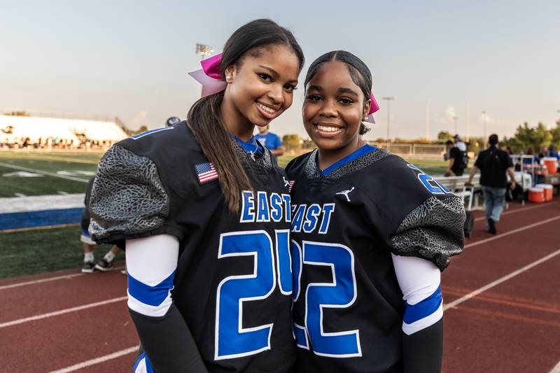 Varsity cheer members Morgan Powell and Savannah Lyons take a photo before a varsity football game against Metea Valley at Lincoln-Way East on Oct. 3, 2025.