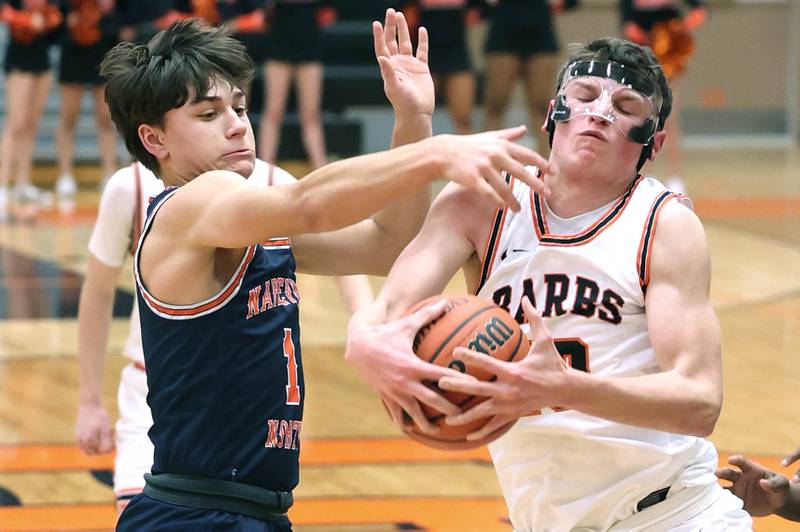 DeKalb's Eric Rosenow grabs a rebound in front of Naperville North's Cole Arl during their game Monday, Jan. 30, 2023, at DeKalb High School.