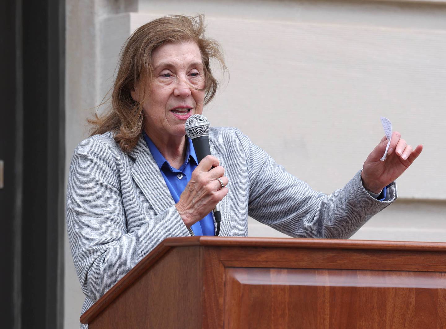 Jill Olson, executive director of CASA DeKalb County, welcomes attendees Tuesday, April 16, 2024, to the Hands Around the Courthouse event in front of the DeKalb County Courthouse in Sycamore. The event, hosted by CASA DeKalb County and Family Service Agency of DeKalb County, was held in honor of National Child Abuse Prevention Month.