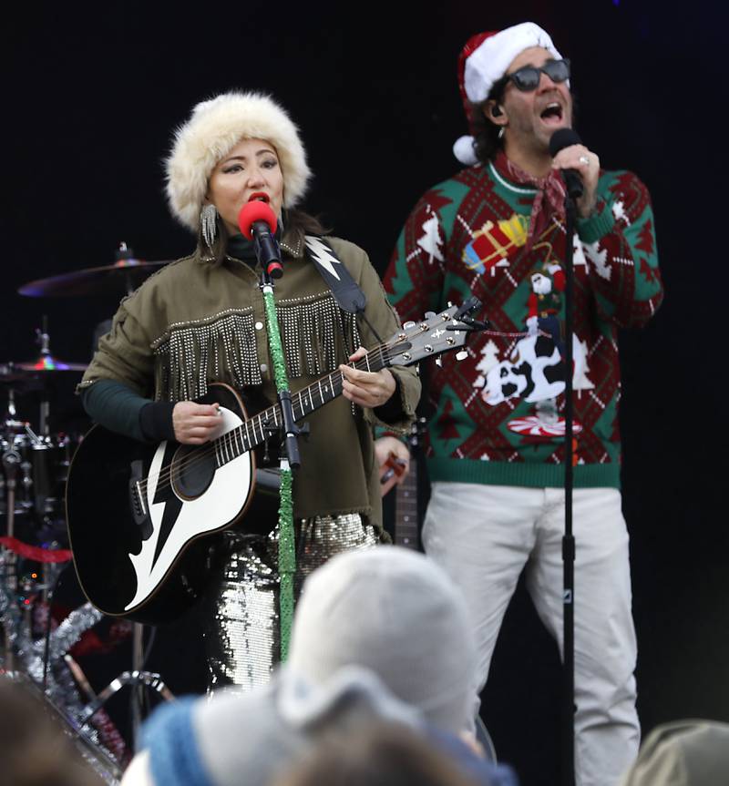 KT Tunstall and Zac Barnett of American Authors sing a song during a stop in Pingree Grove on Wednesday Nov. 27, 2024, by the Canadian Pacific Kansas City Railway 2024 Holiday Train. The holiday train raised food and monetary donations for the D300 Food Pantry during its stop in Pingree Grove.