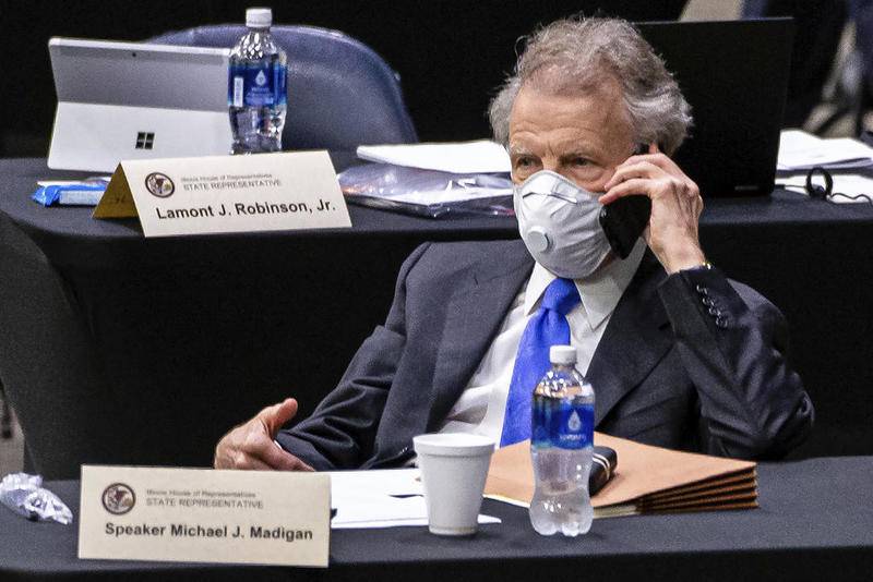 In this May 23, 2020 file photo, Illinois Speaker of the House Michael Madigan, D-Chicago, talks on his cellphone from his desk during an extended session of the Illinois House of Representatives at the Bank of Springfield Center, in Springfield, Ill. ComEd has agreed to pay $200 million to resolve a federal criminal investigation into a long-running bribery scheme that implicates Illinois House Speaker Michael Madigan, the U.S. Attorney's office announced Friday July 17, 2020.