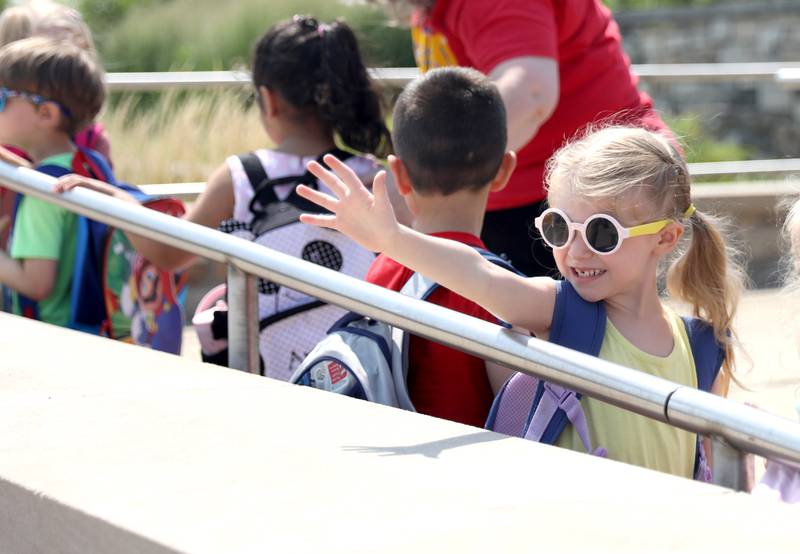 Brenna Gustafson , 4, waves to her mom during the first day of school for the Geneva Early Learning Program on Monday, Aug. 21, 2023.