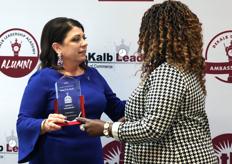 Cortney Strohacker (left) accepts her award from Lucretia Konan for being inducted into the Hall of Fame Thursday, Feb. 8, 2024, during the DeKalb Chamber of Commerce’s Annual Celebration Dinner in the Barsema Alumni and Visitors Center at Northern Illinois University.