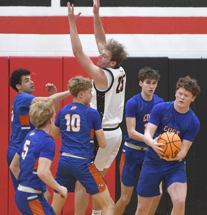 Genoa-Kingston's Jack Peterson (3) comes up with the ball as he and his teammates collapse on Warren's Bryce VanRaalte (25) at the 64th Annual Forreston Holiday Basketball Tournament held at Forreston High School on Saturday, Dec. 13, 2025.