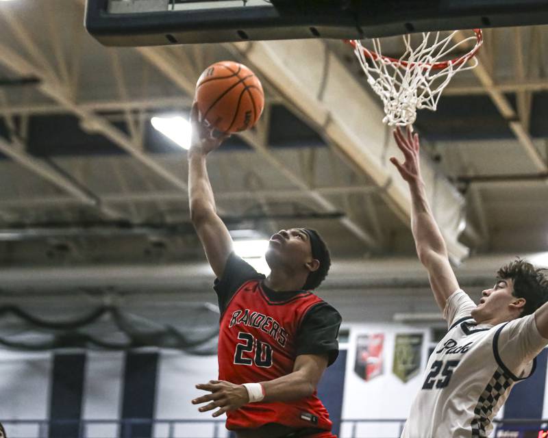 Bolingbrook's Isaiah Rogers (20) puts in a reverse layup during their basketball game between Bolingbrook at Oswego East Friday, Jan 30, 2026 in Oswego.