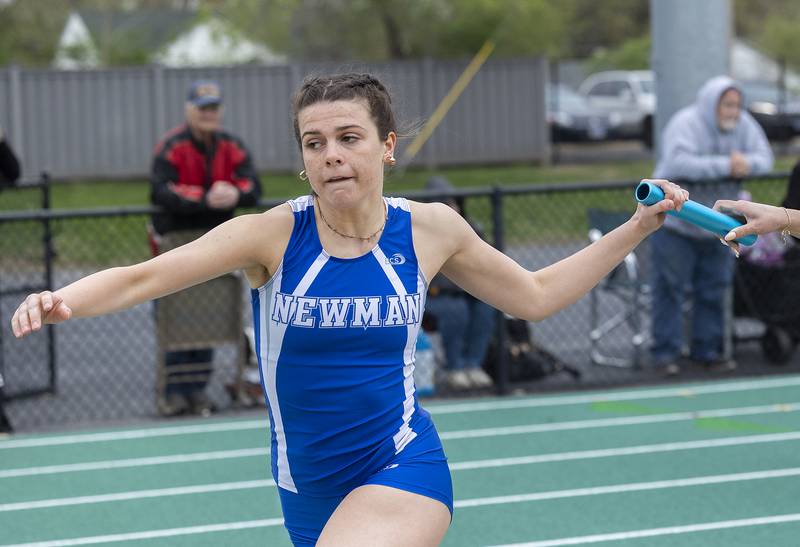 Newman’s Helen Papoccia takes the baton from Brooklyn Smith in the 4x800 Friday, April 25, 2025, during the Rock Falls Rocket Invite.