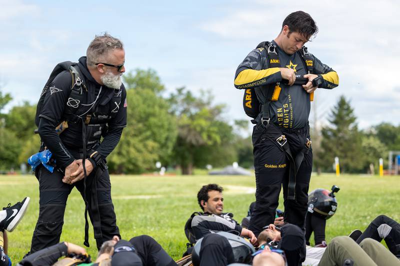 (from left) Rich LaBarr and Jason Bauder gear up before attempting the state record of most jumpers in formation on Wednesday, Aug 20, 2025 at Skydive Chicago in Ottawa.