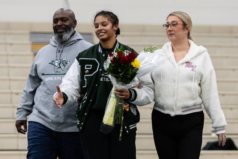 Alicia Tucker walks with her father and mother, Ken and Kelly Tucker, during the Senior Night ceremony before the match at Plainfield Central on January 13, 2025.