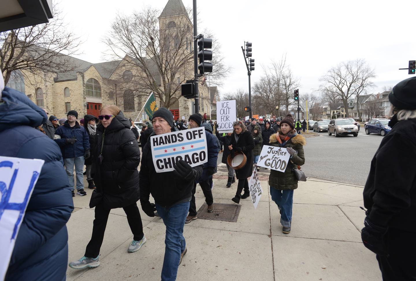 Demonstrators walk along La Grange Road Sunday to protest ICE and the fatal shooting of Renee Nicole Good. More than 800 people attended the event, held in downtown La Grange