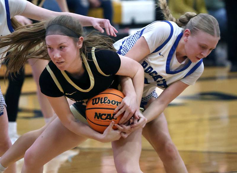 Sycamore's Cortni Kruizenga (left) and Burlington Central's Ashley Waslo fight for the ball Thursday, Feb. 19, 2026, during their Class 3A regional championship game at Sycamore High School.