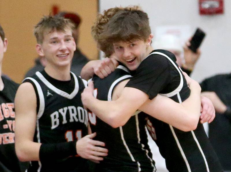 Byron players Cason Newton, Carson Buser and Ryan Tucker celebrate after knocking off Princeton during the Class 2A Sectional final on Friday, March 1, 2023 at Mendota High School.