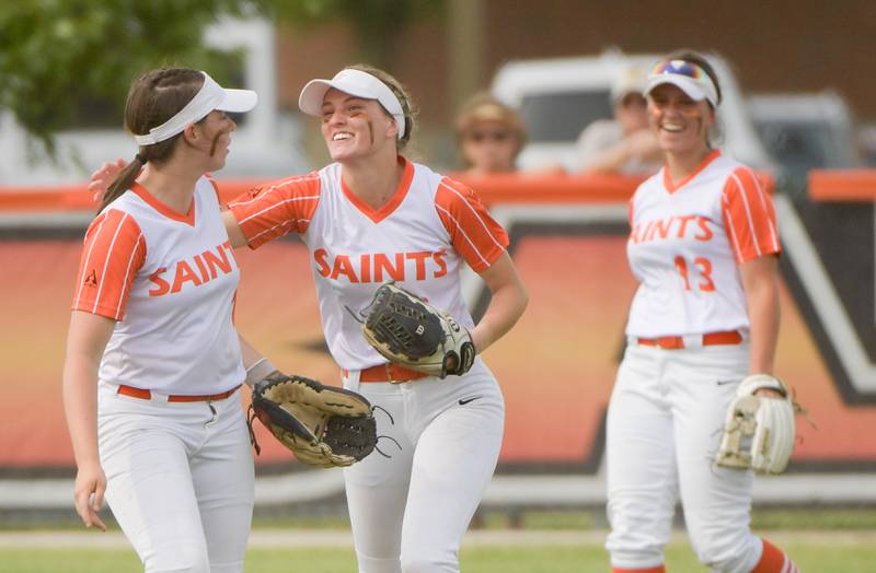 St. Charles East's Sam Beers, left, congratulates Abby Arend, center, on her leaping catch to end the inning against Glenbard North during the Class 4A St. Charles East Sectional semifinal on Tuesday, May 31, 2022.
