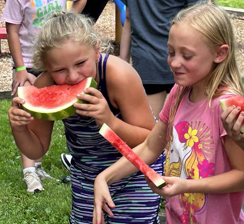 Onalee Siber, 8, and Finley Feldman, 9, of Forreston, laugh as they race to eat their watermelon slices during Sauerkraut Days' Watermelon Eating Contest on Saturday, Aug. 3, 2024. Winners of each age division were awarded a medal and a can of Frank's Sauerkraut.