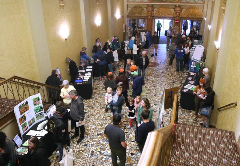 Visitors check out some of booths Thursday, April 18, 2024, during Earth Fest at the Egyptian Theatre in DeKalb. The event, in honor of Earth Week, was presented by DeCarbon DeKalb, in partnership with Northern Illinois University.