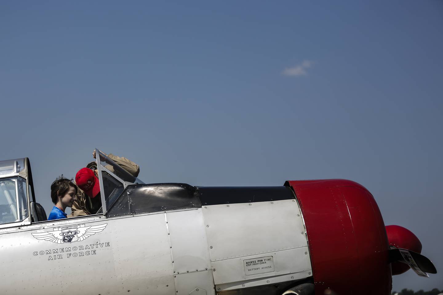 Gary Otto (right) shows Eric Boyce, 11, of Geneva, the cockpit of a SNJ-5 during the 2014 Scout AirFest at Lewis University Airport in Romeoville on Saturday, Aug. 9, 2014.