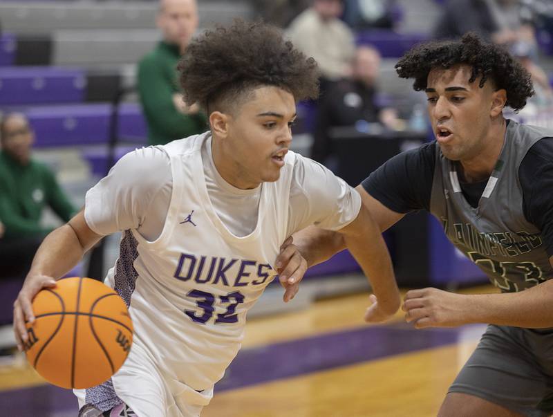 Dixon’s Darius Harrington drives against Plainfield Central’s David Des Garennes Friday, Jan. 3, 2025, at Dixon High School.