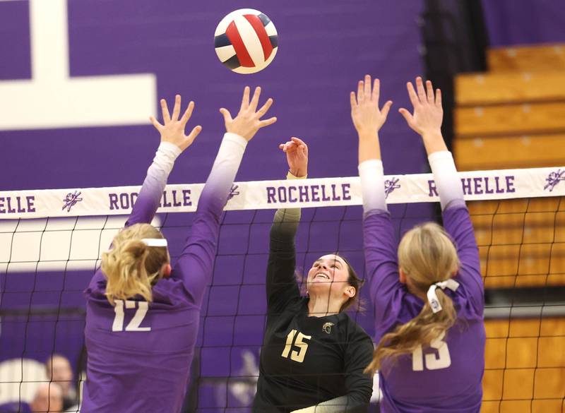 Sycamore's Lillian Jones tries to tip the ball between Rochelle's Jillian Bruns (left) and Reese Kissack Tuesday, Oct. 28, 2025, during their Class 3A regional semifinal match at Rochelle High School.