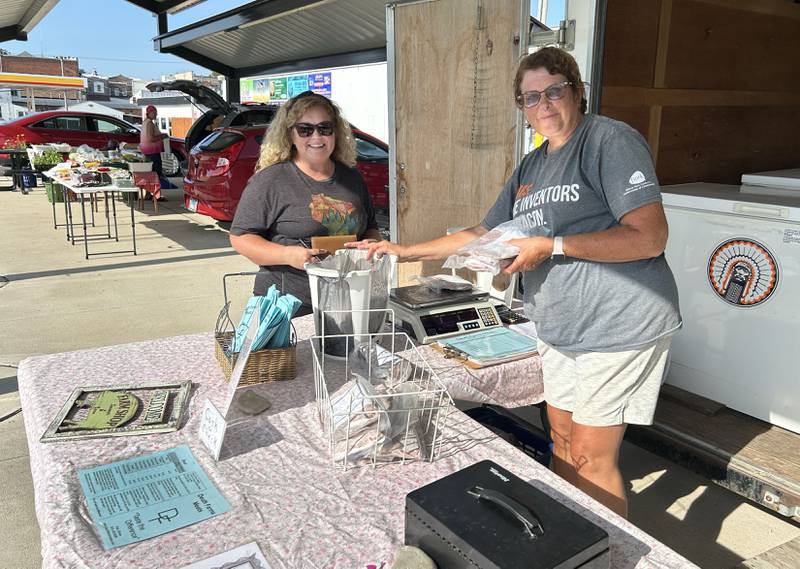 Jean Deuth waits on Lori Walker as she makes a purchase at the Deuth Farms Meats booth at the Polo Farmer's Market on Thursday, Aug. 7, 2025. The market is held each Thursday from 3-6 p.m., weather permitting, at the Pavilion located on the southeast corner of South Division and Buffalo Street.