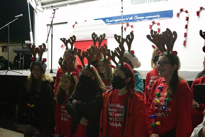 Wearing barrettes sporting reindeer antlers, the Traughber Junior High School Choir performed Dec. 3 during the tree lighting ceremony and Christmas Walk celebration in Oswego.