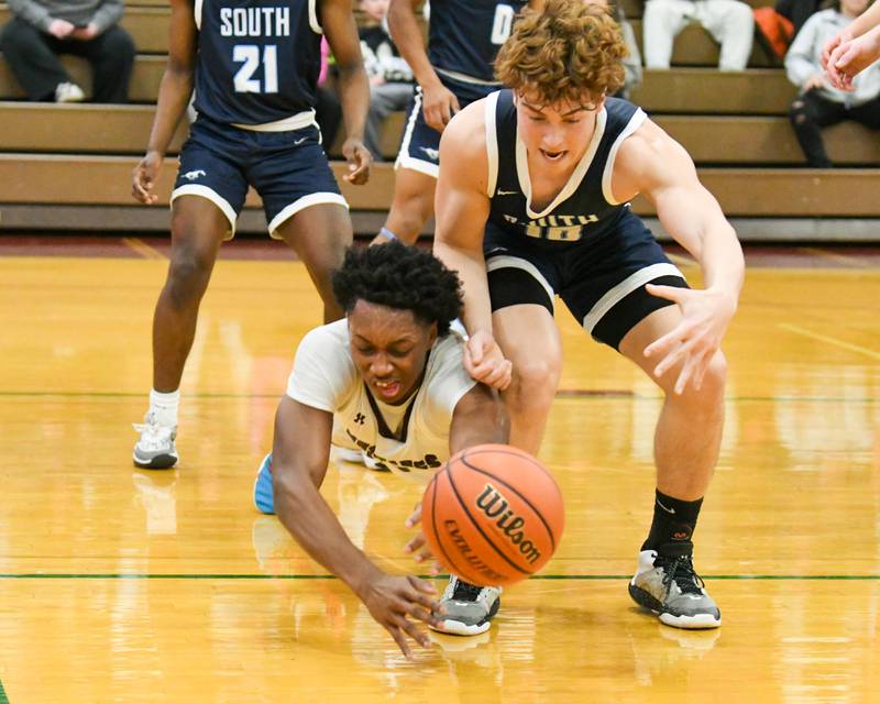 Morton East's Tyler Nichols, left and Downers Grove South's Dominic Marcantelli, right, go after a free ball in the second quarter on Saturday Dec. 9, 2023, while being played at Morton East High School.