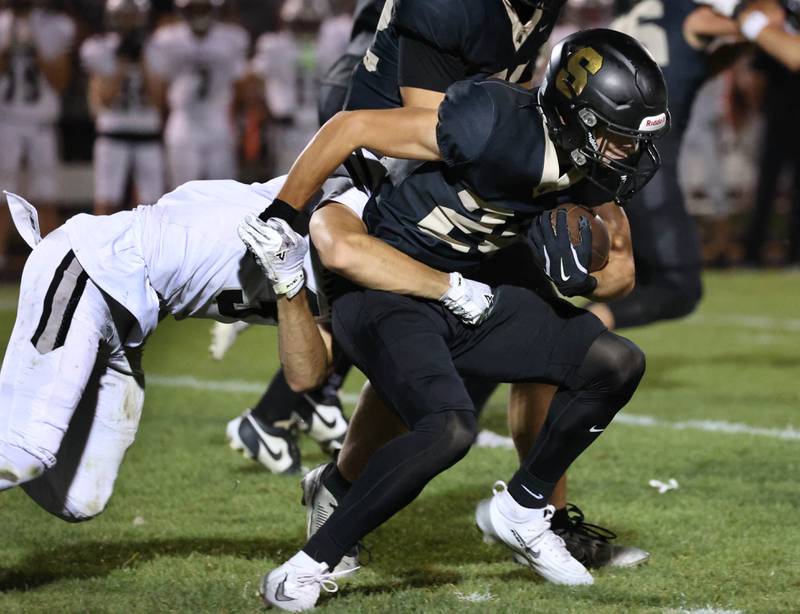 Sycamore's Crewe Bartelt is brought down by Kaneland's Luke Gadomski during their game Friday, Oct. 3, 2025, at Sycamore High School.