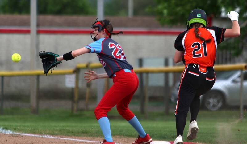Marian Central’s Kaylie Kowalsky, left, fields the toss as as Winnebago’s Kyla Warkentien is out at first base as the teams  to began an IHSA Class 2A Regional game at Raymond Benoy Field in Woodstock Monday.