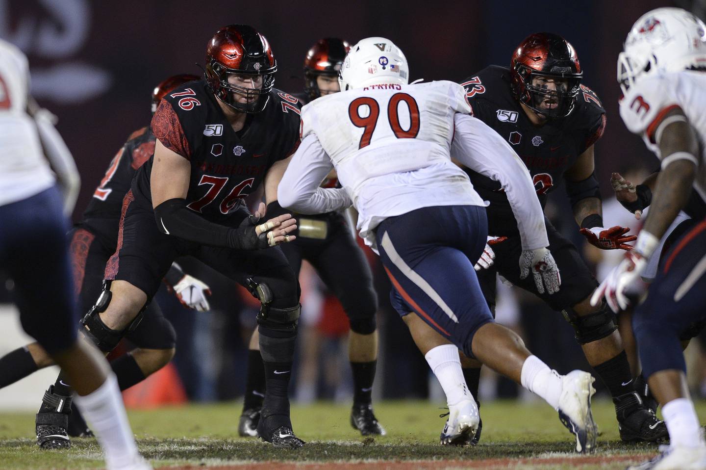 San Diego State offensive lineman Zachary Thomas, left, blocks Fresno State defensive tackle Kevin Atkins during a game on Nov. 15, 2019, in San Diego.
