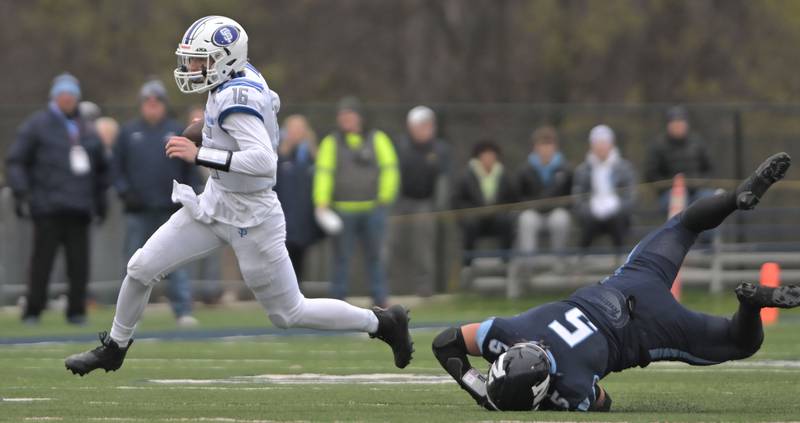 St. Francis quarterback Brady Palmer outruns Nazareth’s Gabe Kaminski in the second quarter in the IHSA Class 5A state semifinal football game in La Grange on Saturday, Nov. 23, 2024.
