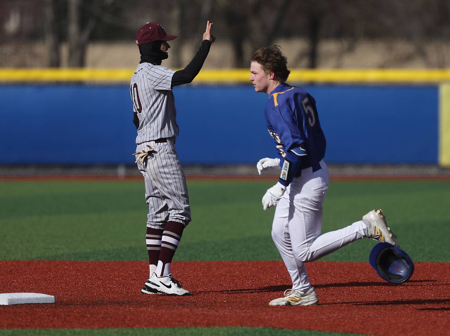 Johnsburg's Nate Frost round second base one his way to a trip as Richmond-Burton's Ryan Scholberg waits for the throw during a Kishwaukee River Conference baseball game on Monday, April 6,2026, at Johnsburg High School.