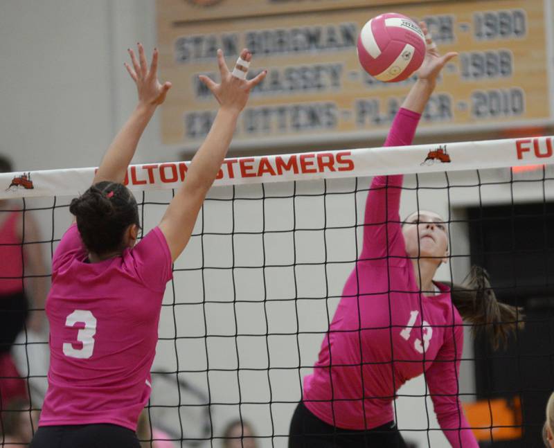 Eastland's Vanessa Allen (13) spikes as Fulton's Kerby Germann (3) goes up to block during a Tuesday, Oct. 7, 2025 match in Fulton.
