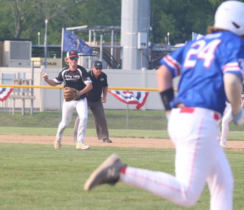 Spring Valley's Drew Carlson throws out  Michigan's Dylan Geimon on a run to first base during the Central Region Baseball Tournament on Monday, July 24, 2023 at Washington Park in Peru.