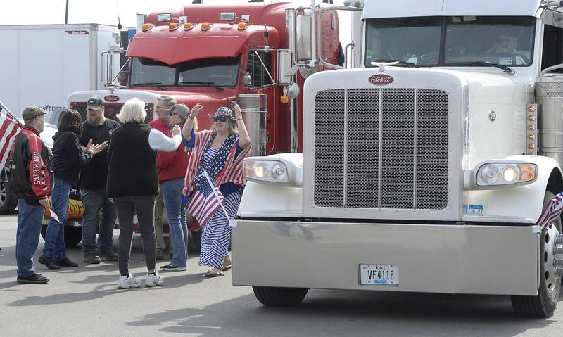 Semi truck drivers not part of the American Freedom Convoy interact Saturday, March 5, 2022, with those attending the rally at Love’s Travel Stop in Oglesby.