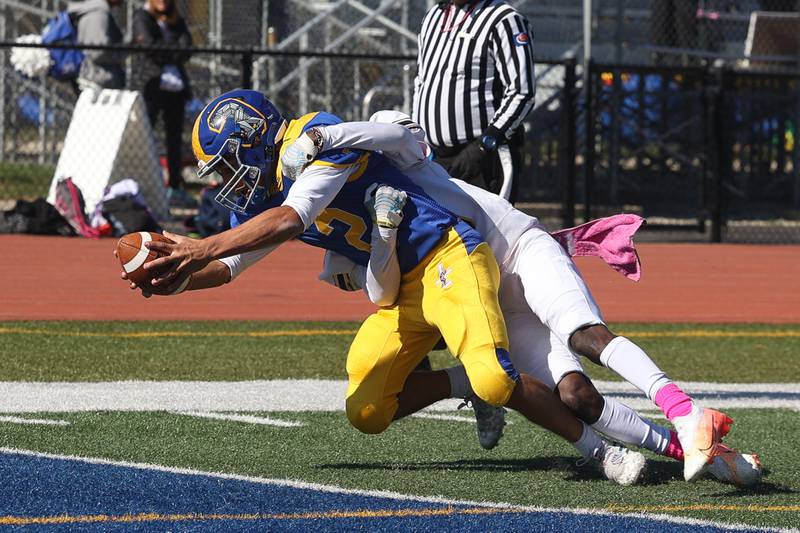 Joliet Central’s Christian Smith stretches the ball across the goal line after a catch and run against Joliet West on Saturday.