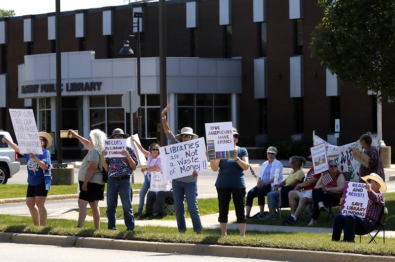 Protesters line Route 31 in front of the McHenry Public Library on Friday, June 20, 2025, during a Save Our Libraries Protest hosted by Indivisible McHenry County to draw attention to cuts to the nation’s libraries by the Trump administration.