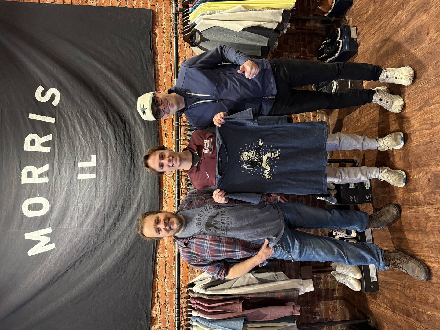 GAVC instructor Joe Terrel, winning t-shirt designer Brodie Peterson, and Field Day owner Patrick Keegan.