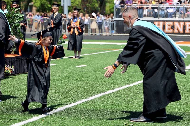 Patricia Stypulkowski greats Principal Jeff Prickettt Saturday, May 20, 2023, during the McHenry Community High School Graduation Ceremony for class of 2023 at McCracken Athletic Field in McHenry.