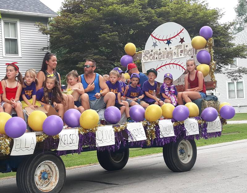 The Serena T-ball team rides along West Grant Street, Monday, July 4, 2022, in Sheridan during the village's Independence Day parade, which doubled also celebrated the village's sesquicentennial.