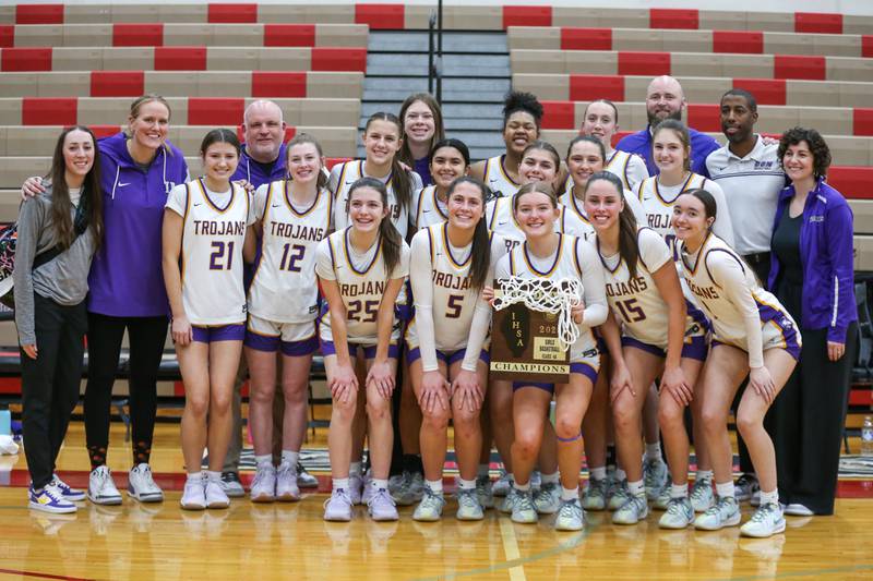 Downers Grove North poses with the  Regional Final basketball game plaque after defeating Plainfield North. Feb 20, 2025 in Plainfield.